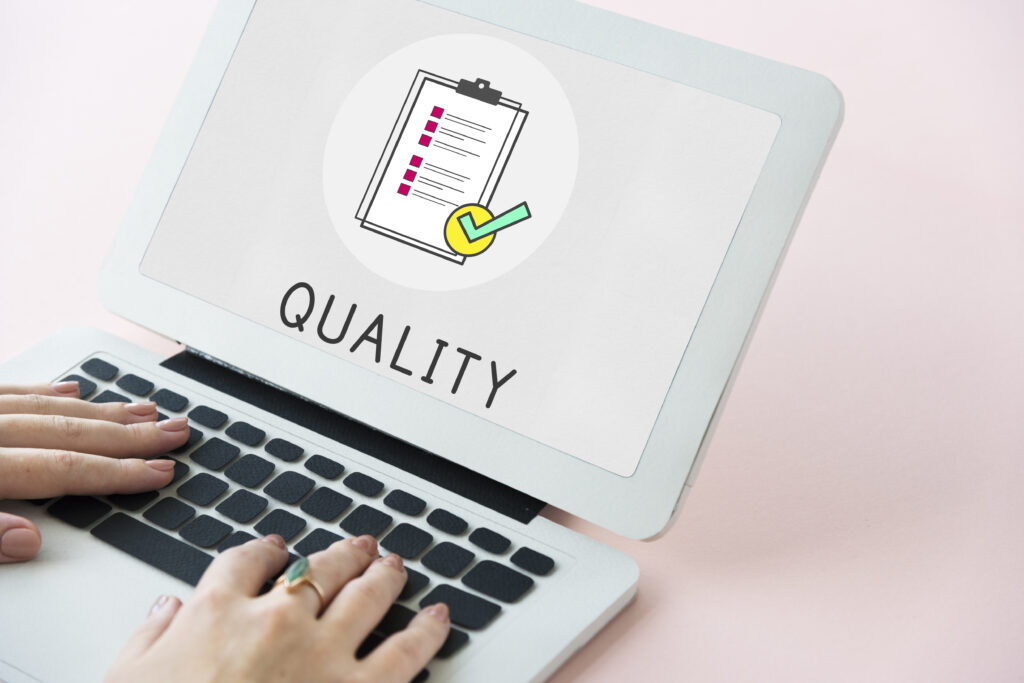 Image of a laptop with a Quality Assurance Clipboard Icon on the screen